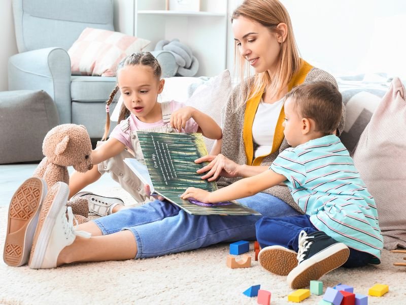 Mother reading to her son and daughter