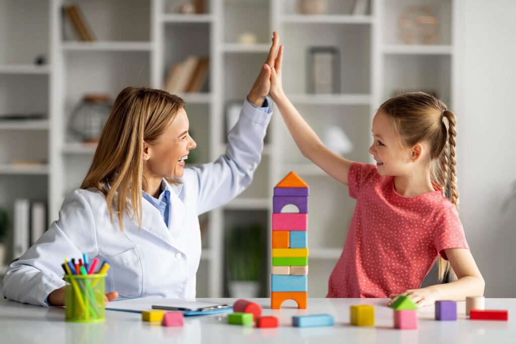 Nanny giving a high five to a little girl